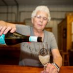 woman pouring glass of Bubbly Candeo